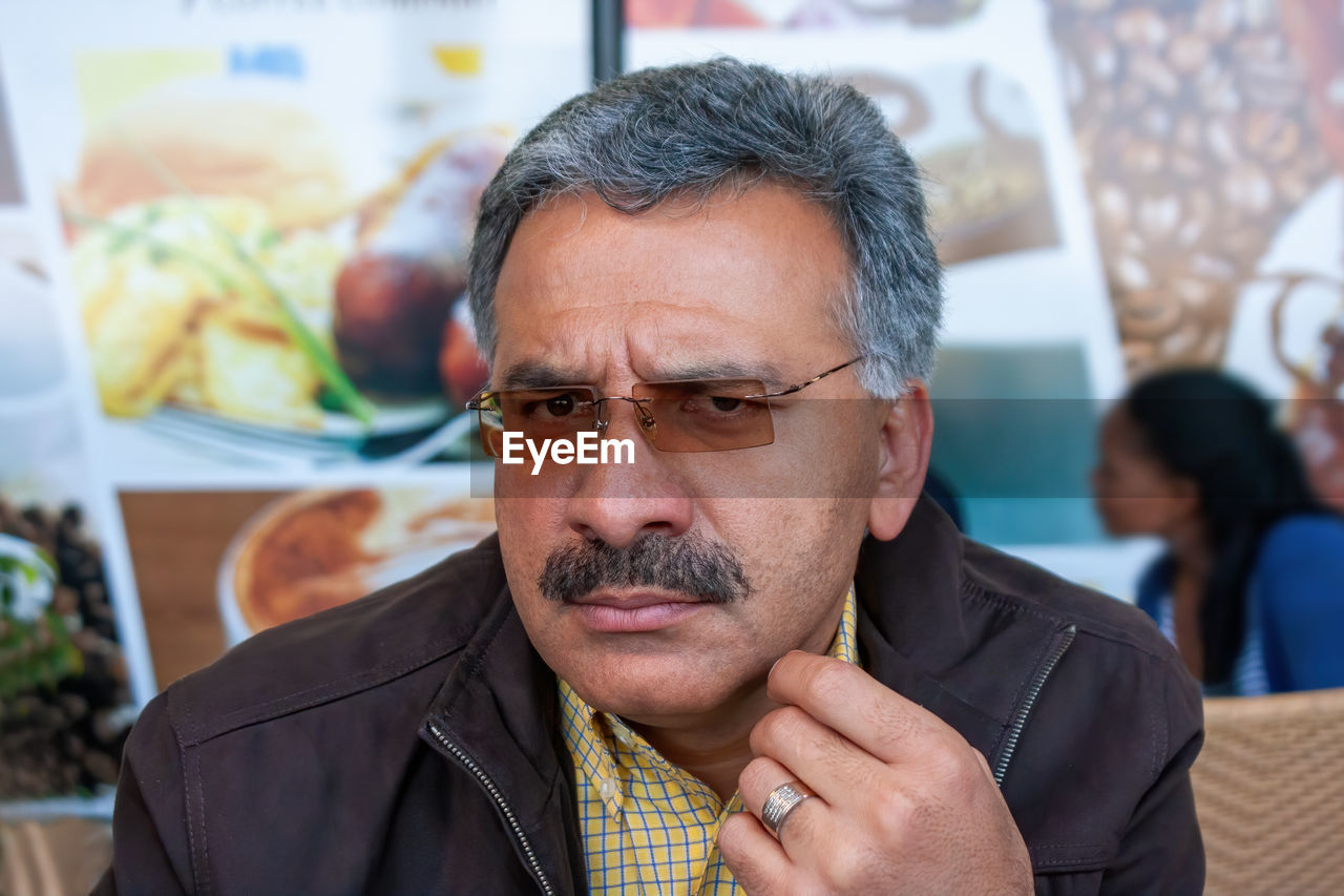 Close-up portrait of man wearing eyeglasses