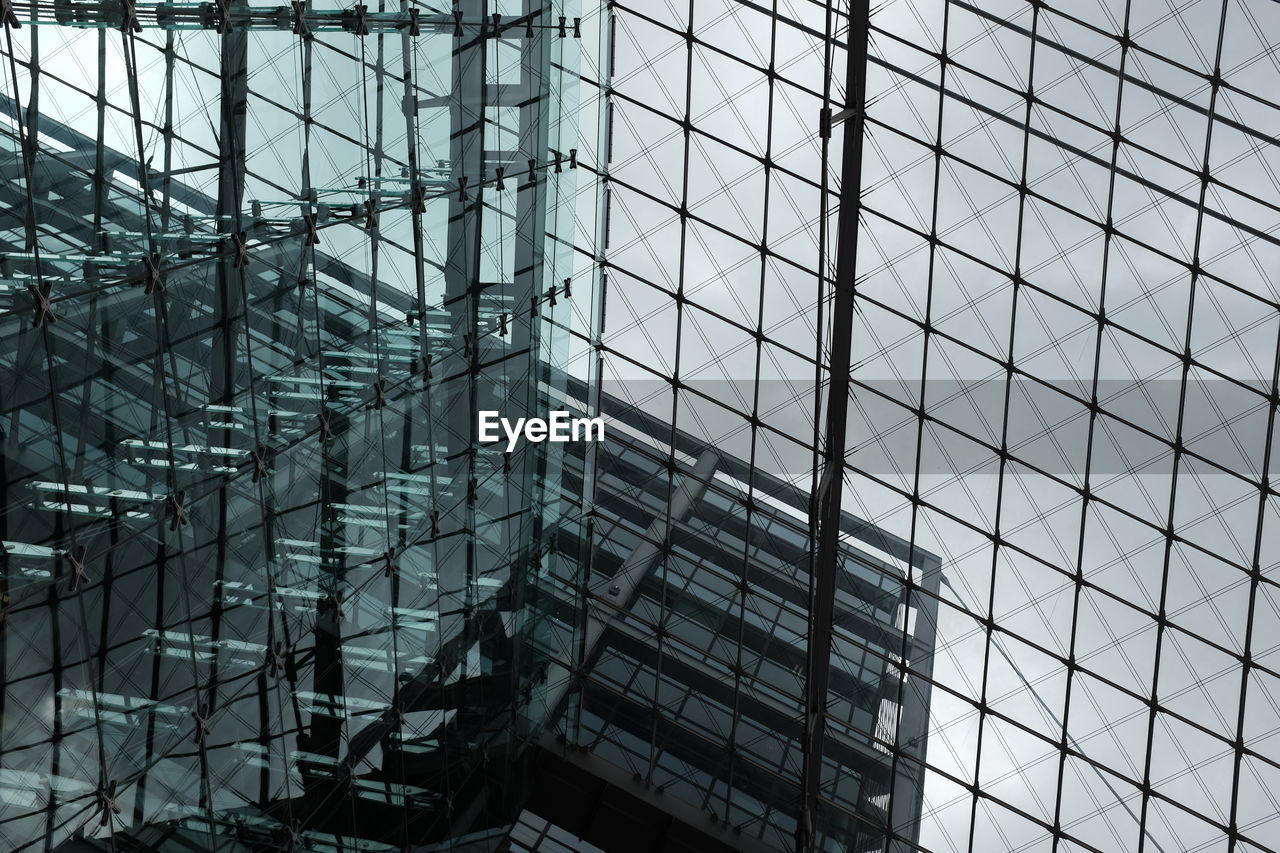 Double exposure of modern building against sky