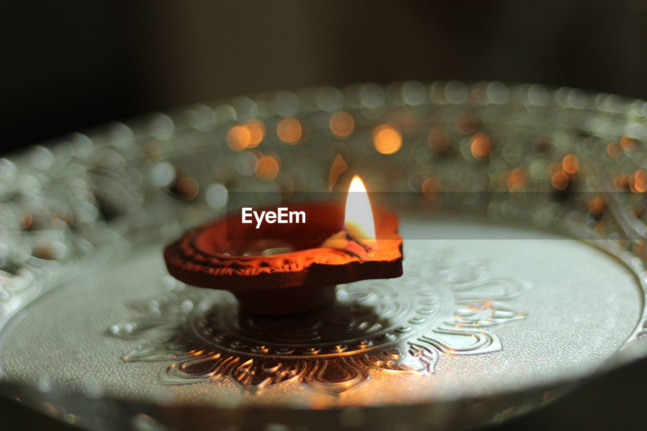 Close-up of burning diya