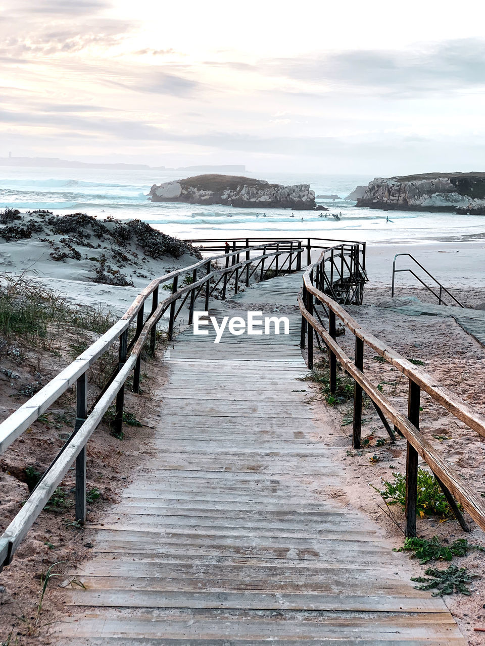 Scenic view of a wooden path to the sea against sky 