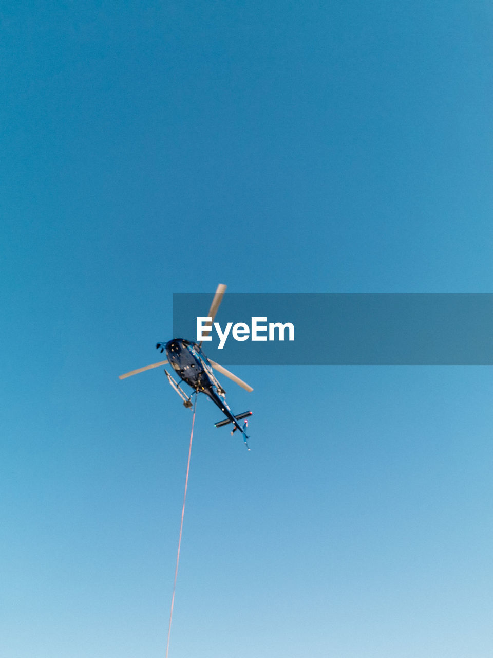 LOW ANGLE VIEW OF AIRPLANE FLYING IN SKY
