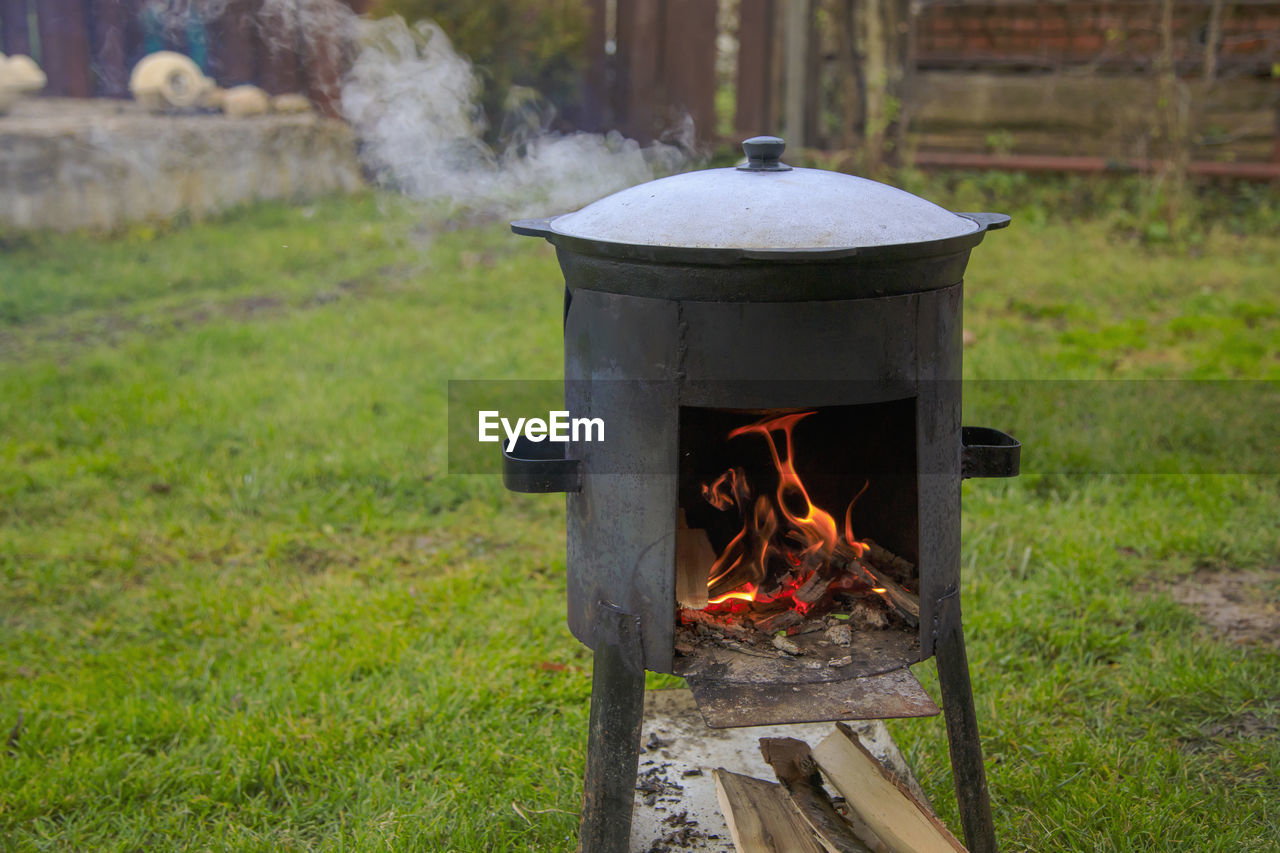 Cooking in a cauldron on the fire. picnic outdoors in summer.