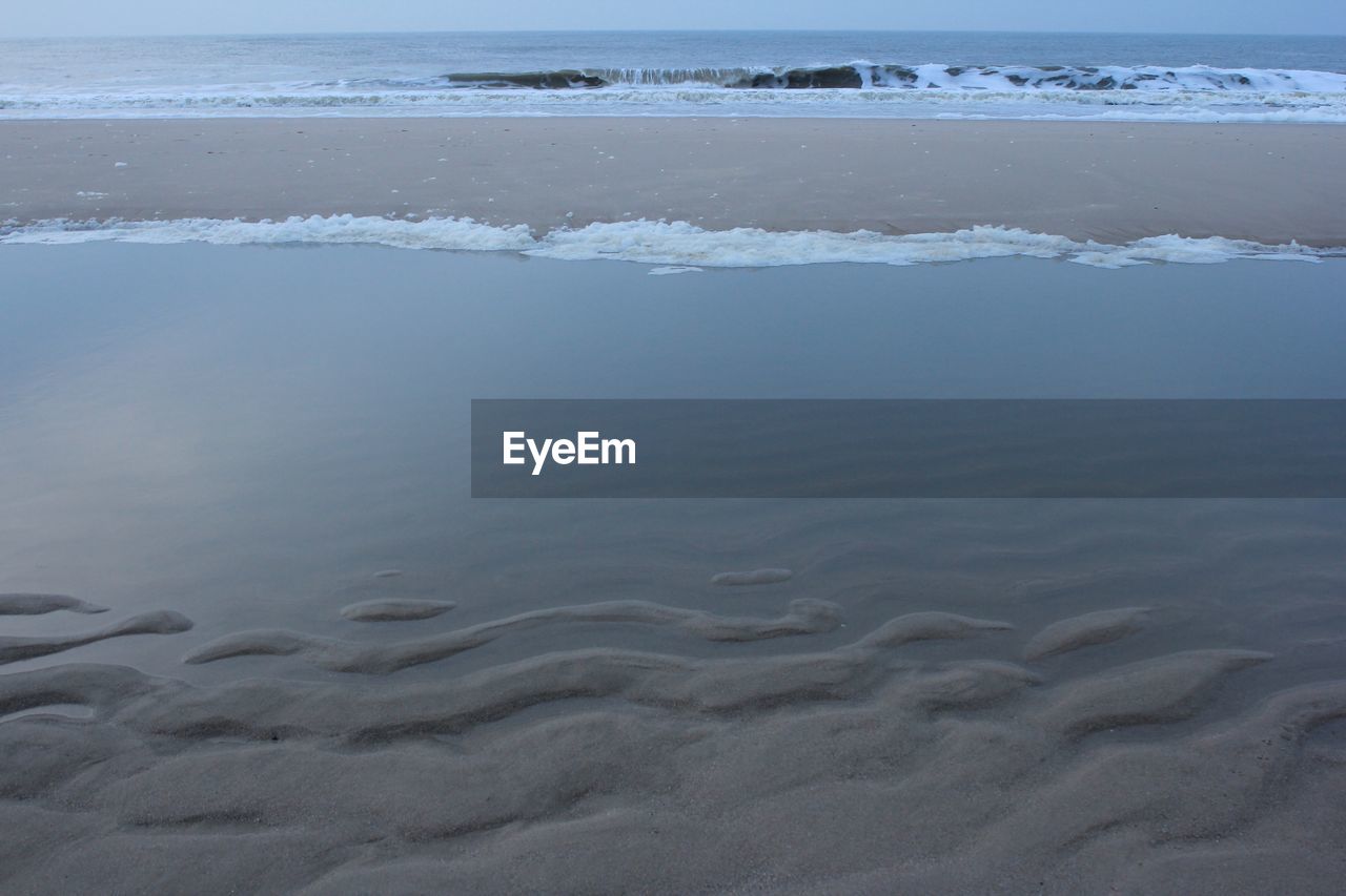 SURFACE LEVEL OF SEA AGAINST SKY