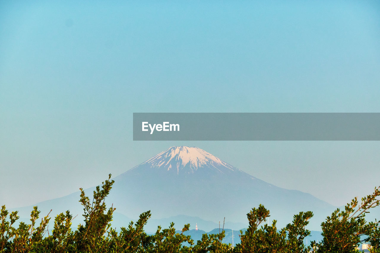 Scenic view of snowcapped mountains against clear sky