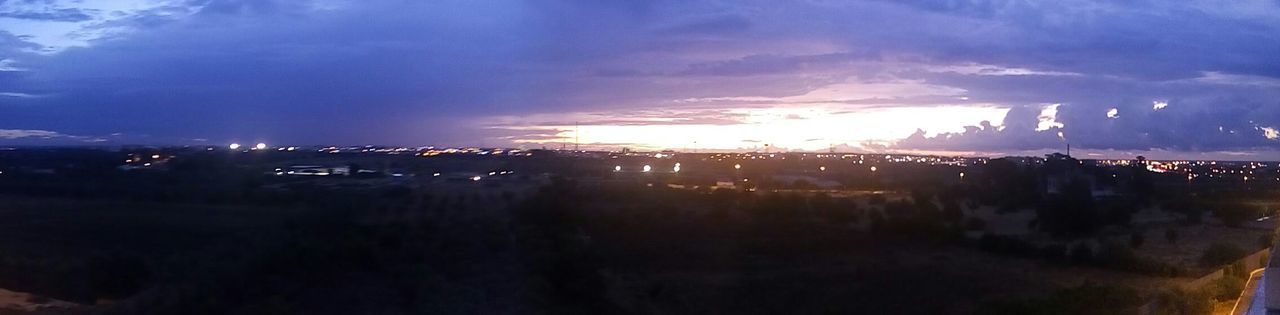 VIEW OF ILLUMINATED CITY AT NIGHT