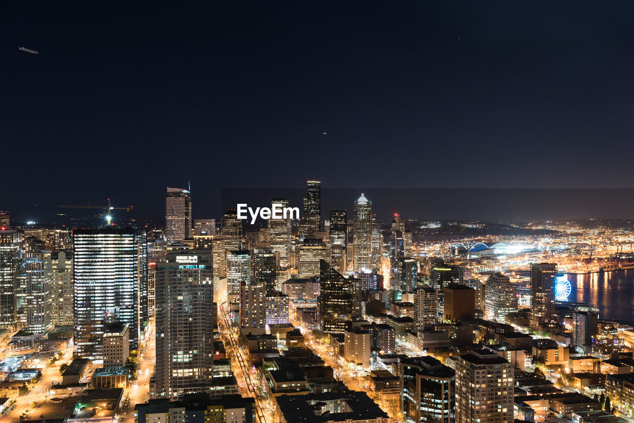 ILLUMINATED CITY BUILDINGS AGAINST SKY