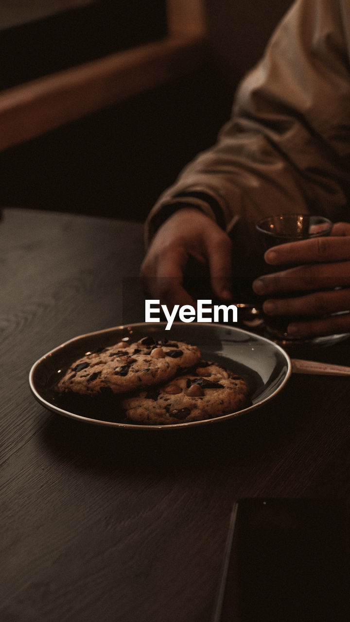 Midsection of man sitting on table