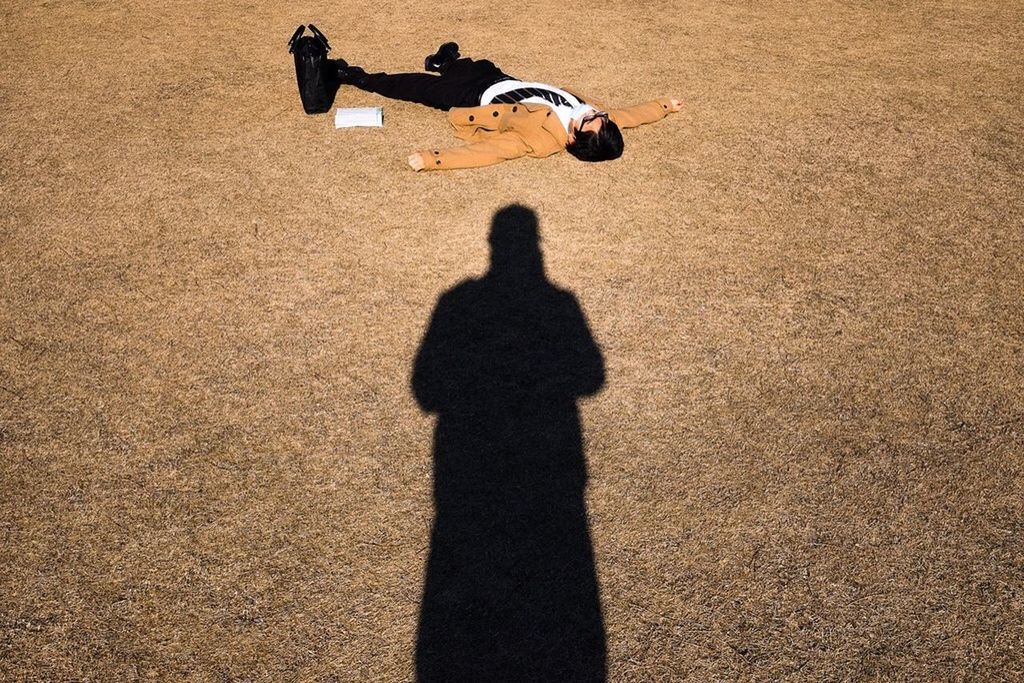 SHADOW OF WOMAN ON WALL