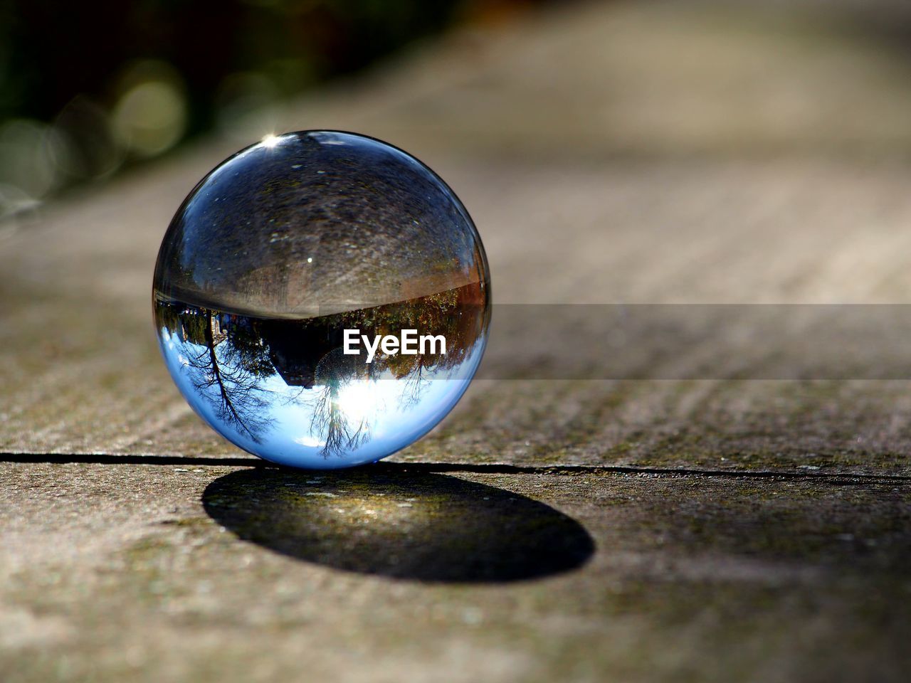 Close-up of crystal ball on wooden surface