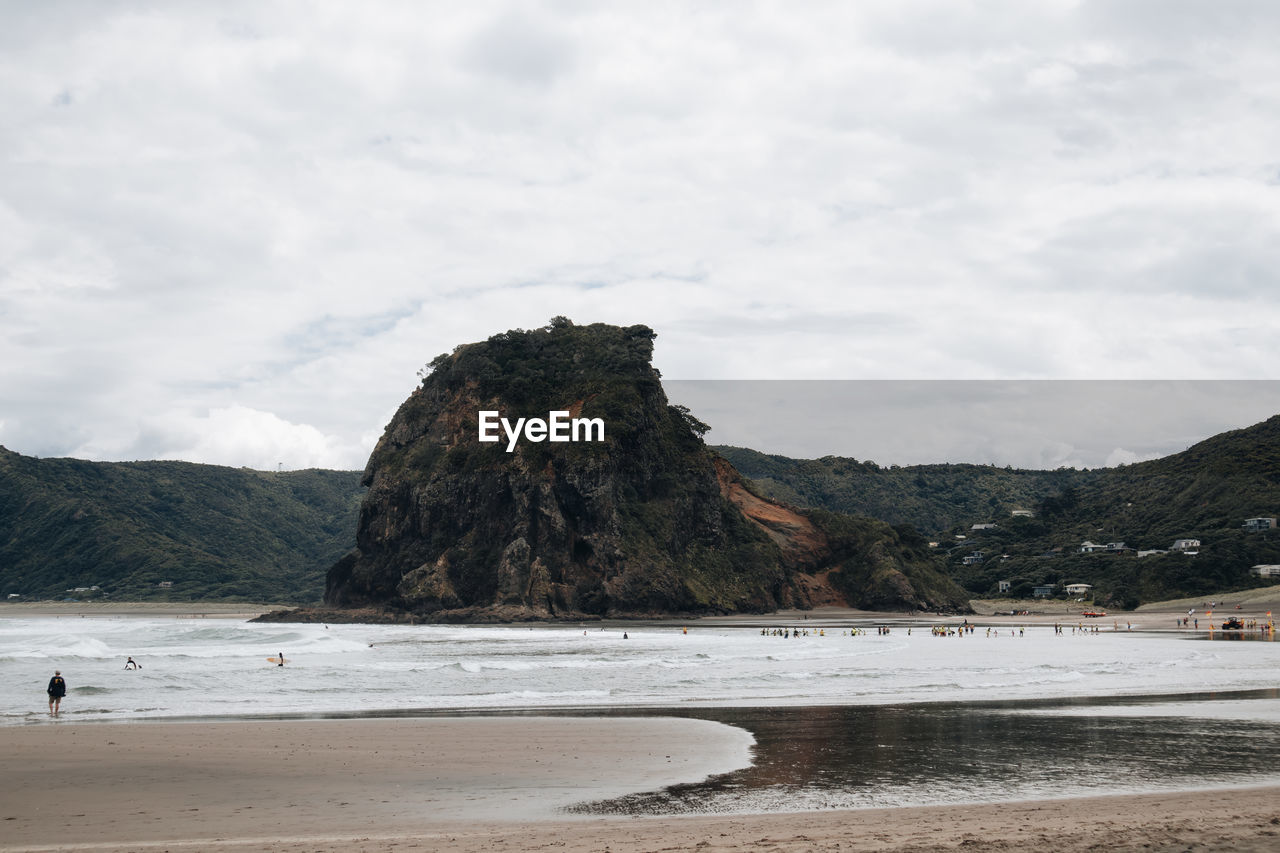 land, water, beach, sea, coast, body of water, shore, sky, scenics - nature, mountain, ocean, beauty in nature, cloud, nature, rock, environment, bay, sand, landscape, travel destinations, wave, tranquility, tranquil scene, day, non-urban scene, travel, outdoors, coastline, rock formation, no people, holiday, tourism, trip, animal wildlife, vacation