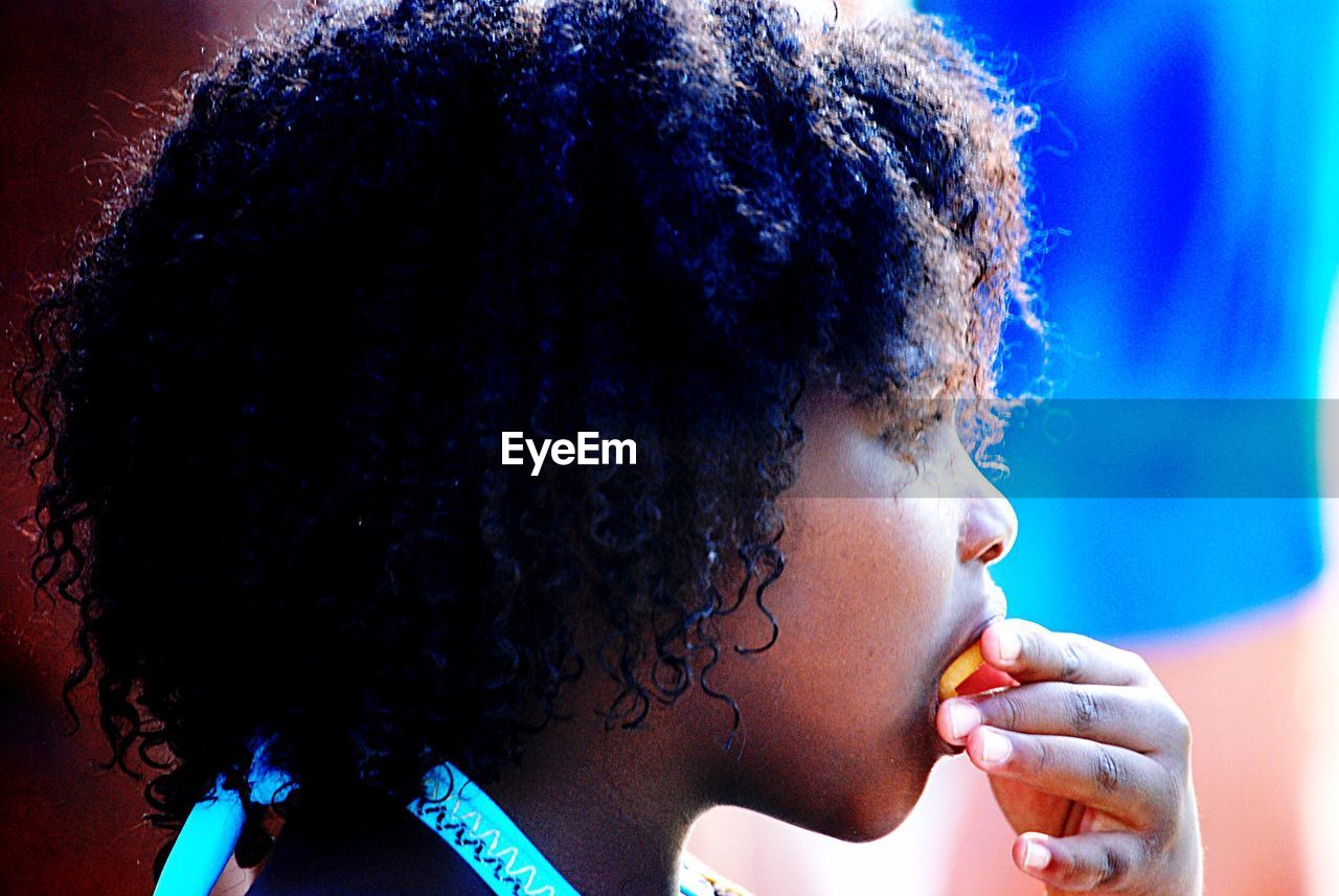 Side view of girl eating food