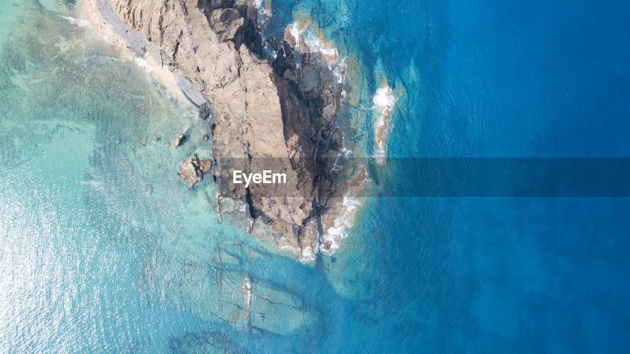 HIGH ANGLE VIEW OF SWIMMING POOL AND SEA