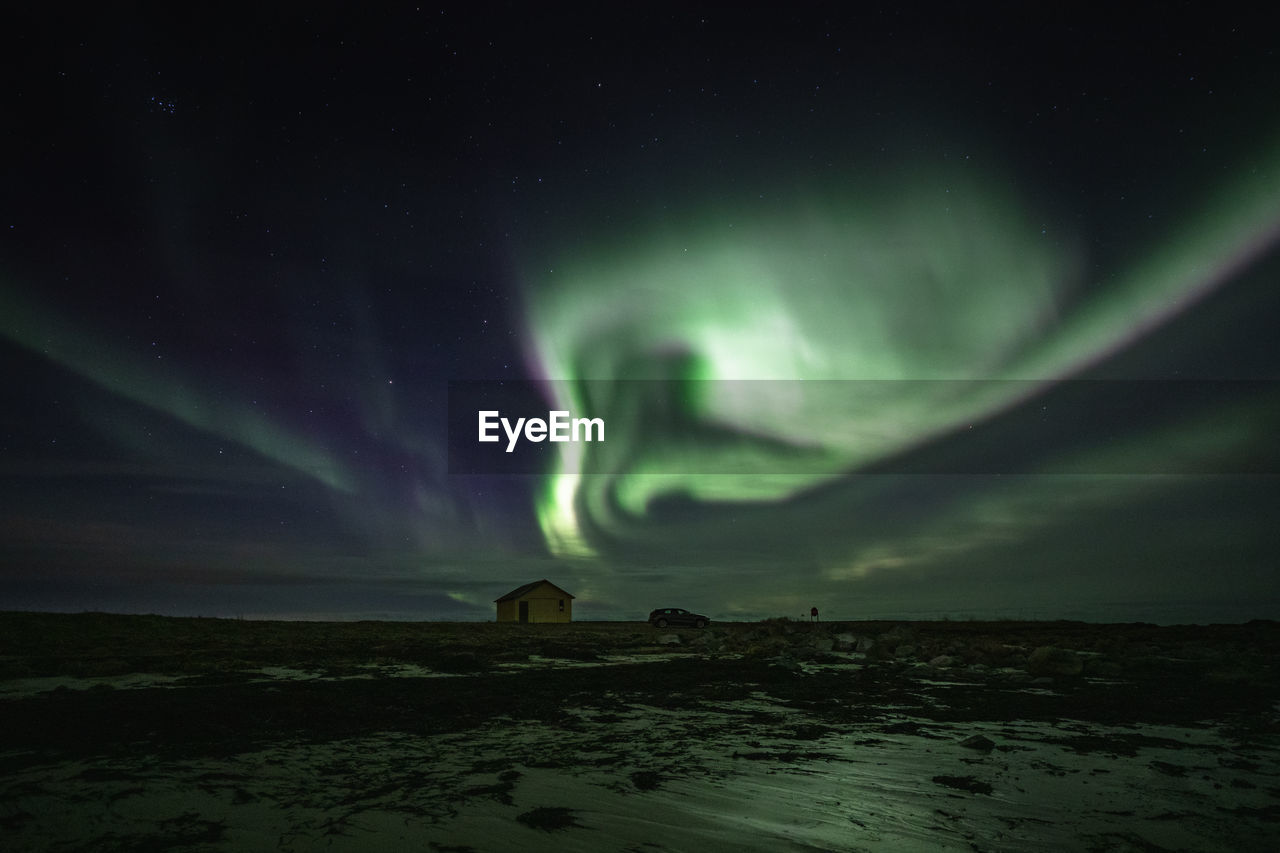 Scenic view of land against sky at night