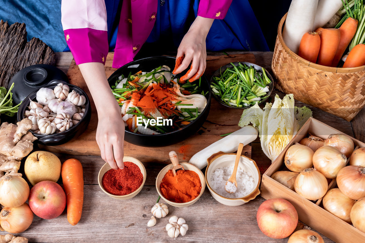 MIDSECTION OF MAN PREPARING FRUITS