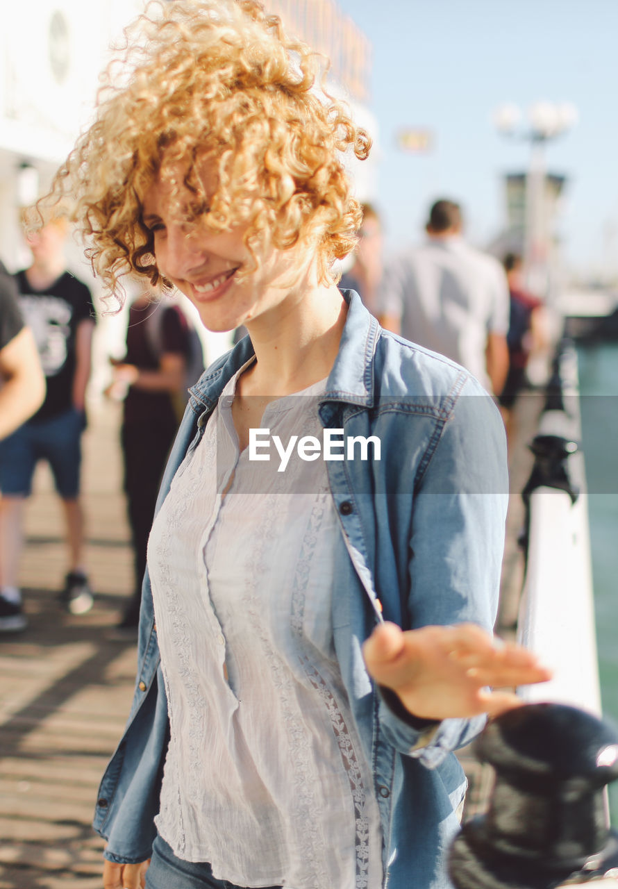 Smiling woman standing on pier