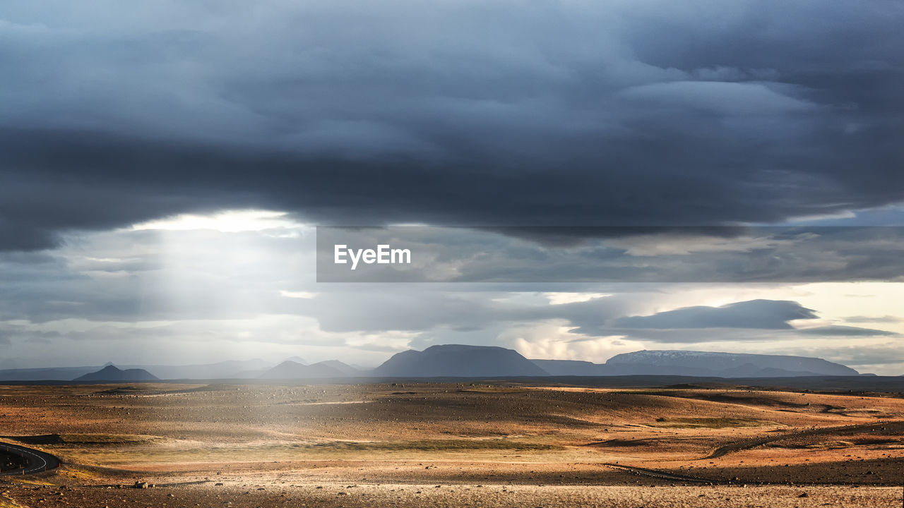 A stony landscape with clouds and sun in the north of iceland