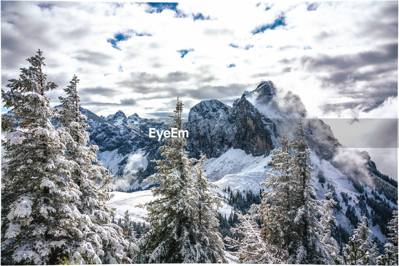 Low angle view of snowcapped mountains against sky