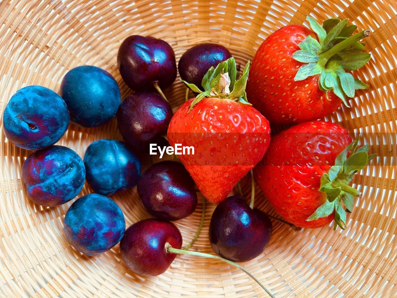 Strawberries, plums, cherries in basket. fresh, colourful, juicy, sweet, nutritious, summer fruit.