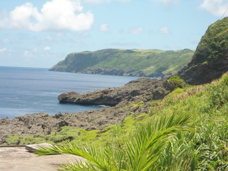 SCENIC VIEW OF SEA WITH MOUNTAIN RANGE IN BACKGROUND