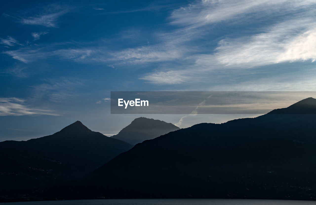 Scenic view of silhouette mountains against sky during sunset