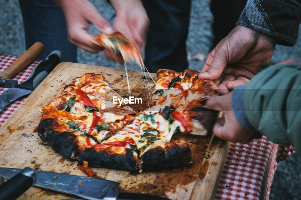 Friends having pizza on table