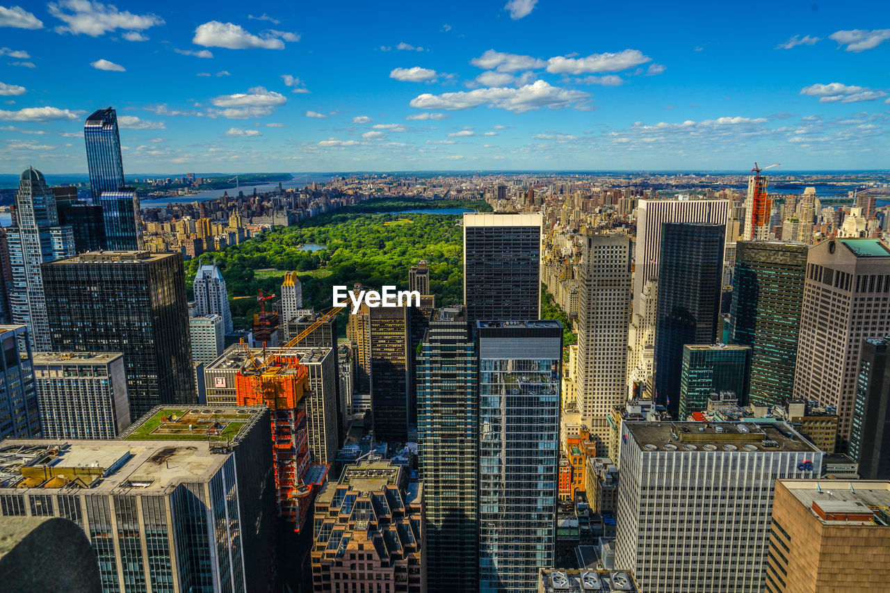 aerial view of buildings in city against sky