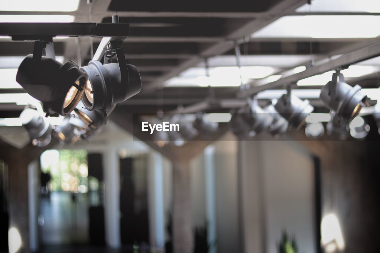 Low angle view of lighting equipment hanging in factory