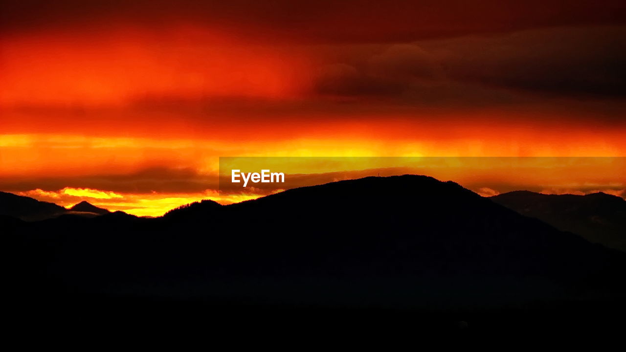 Scenic view of silhouette mountain against sky during sunset