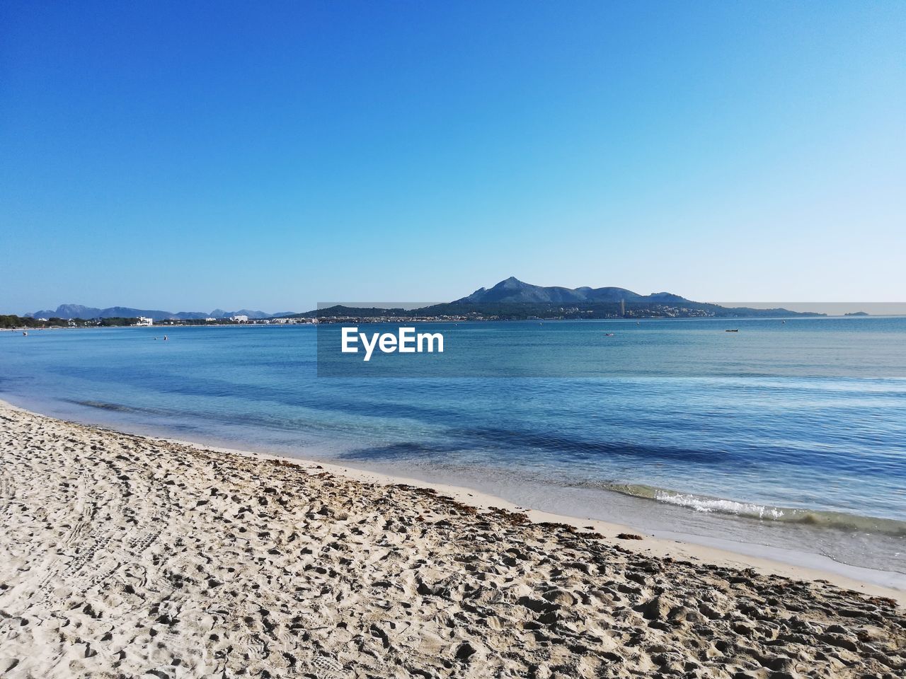 Scenic view of sea against clear blue sky