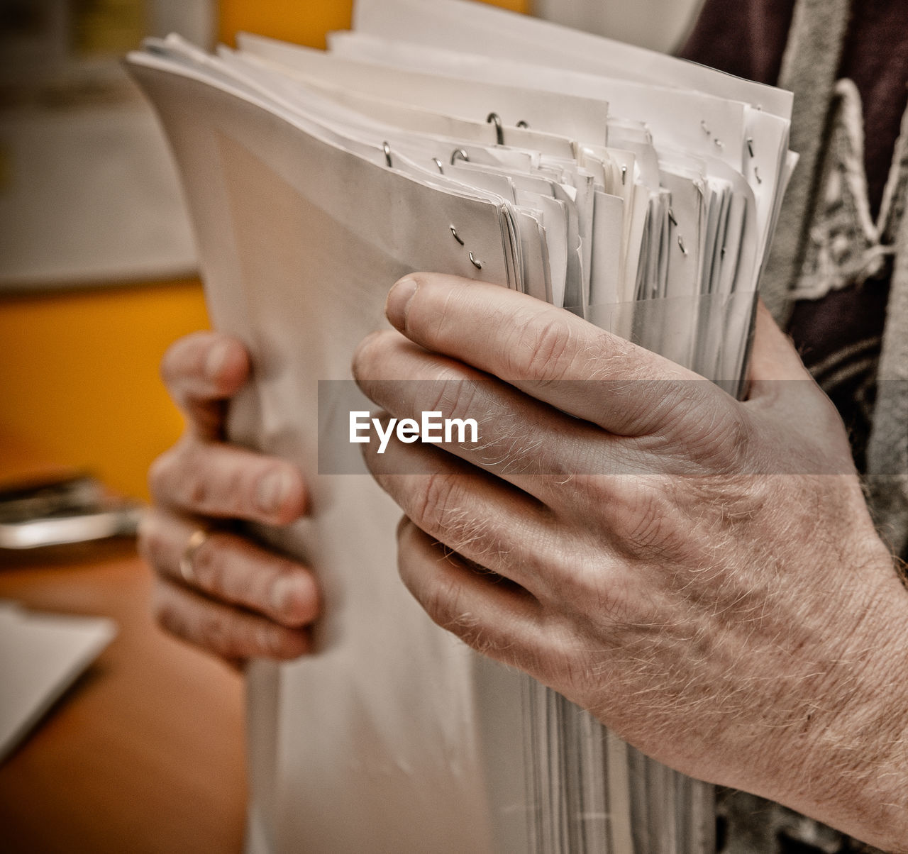 Close-up of man holding papers