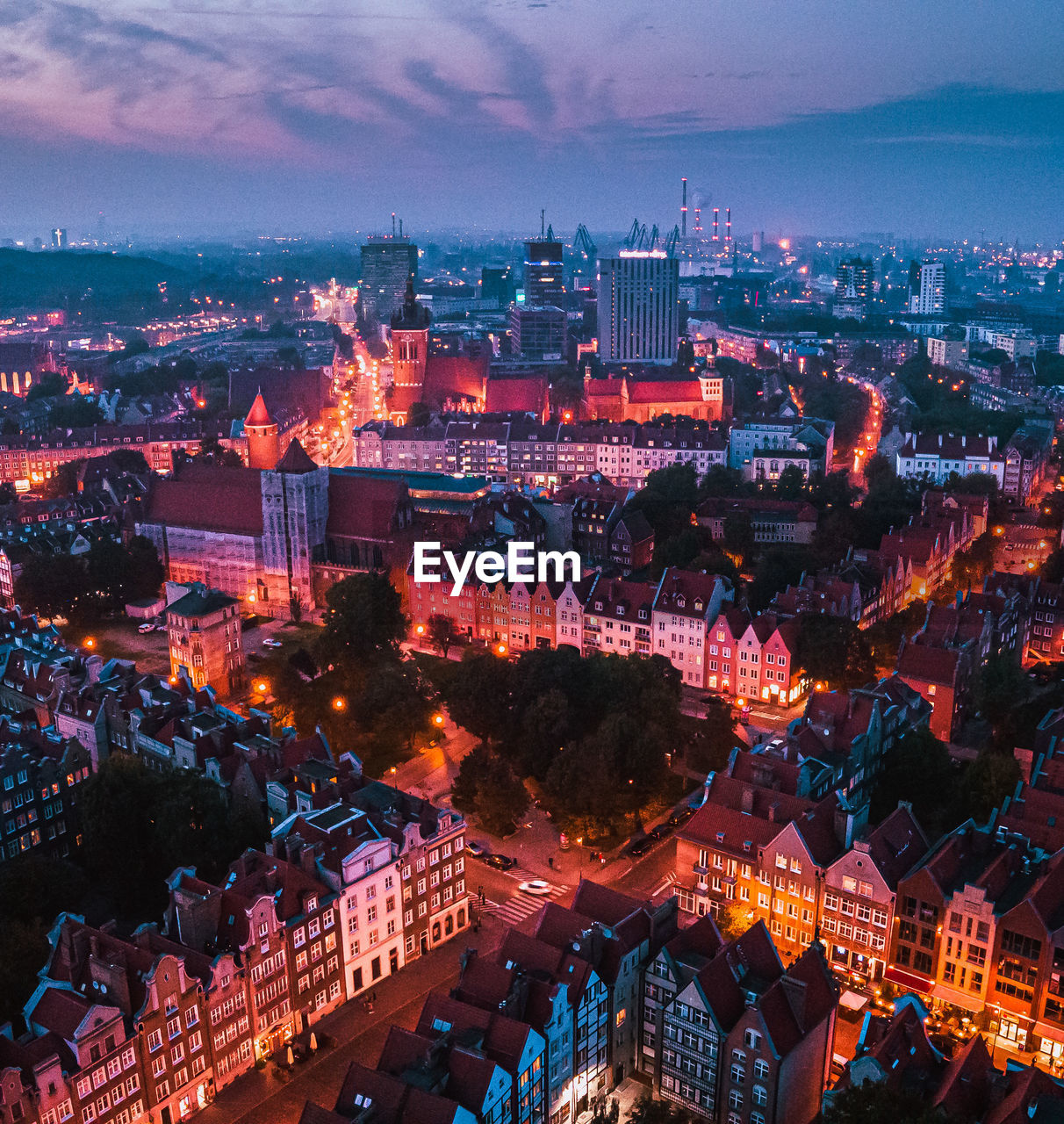 High angle view of illuminated cityscape against sky at dusk