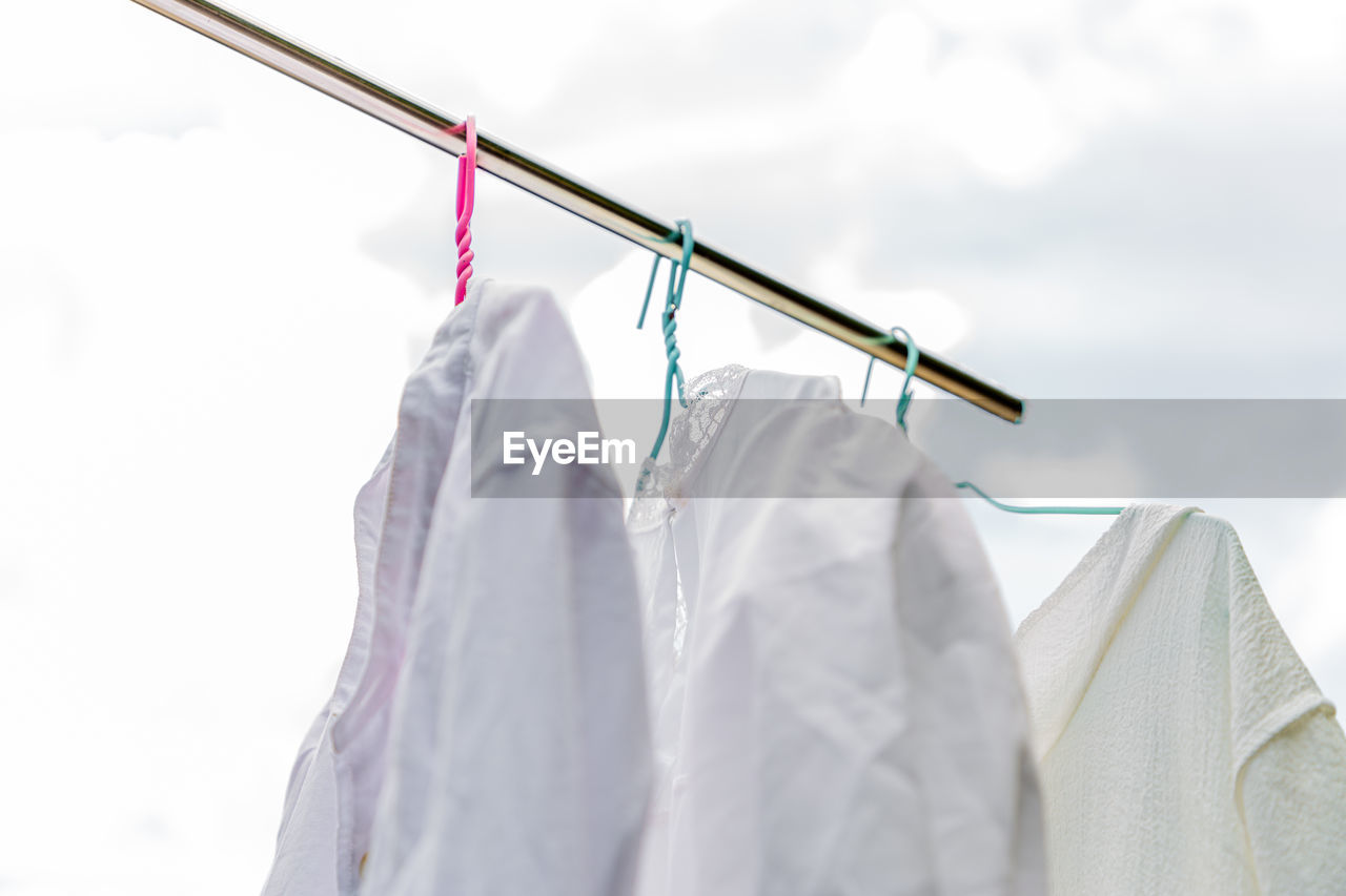 Low angle view of clothes drying on white background