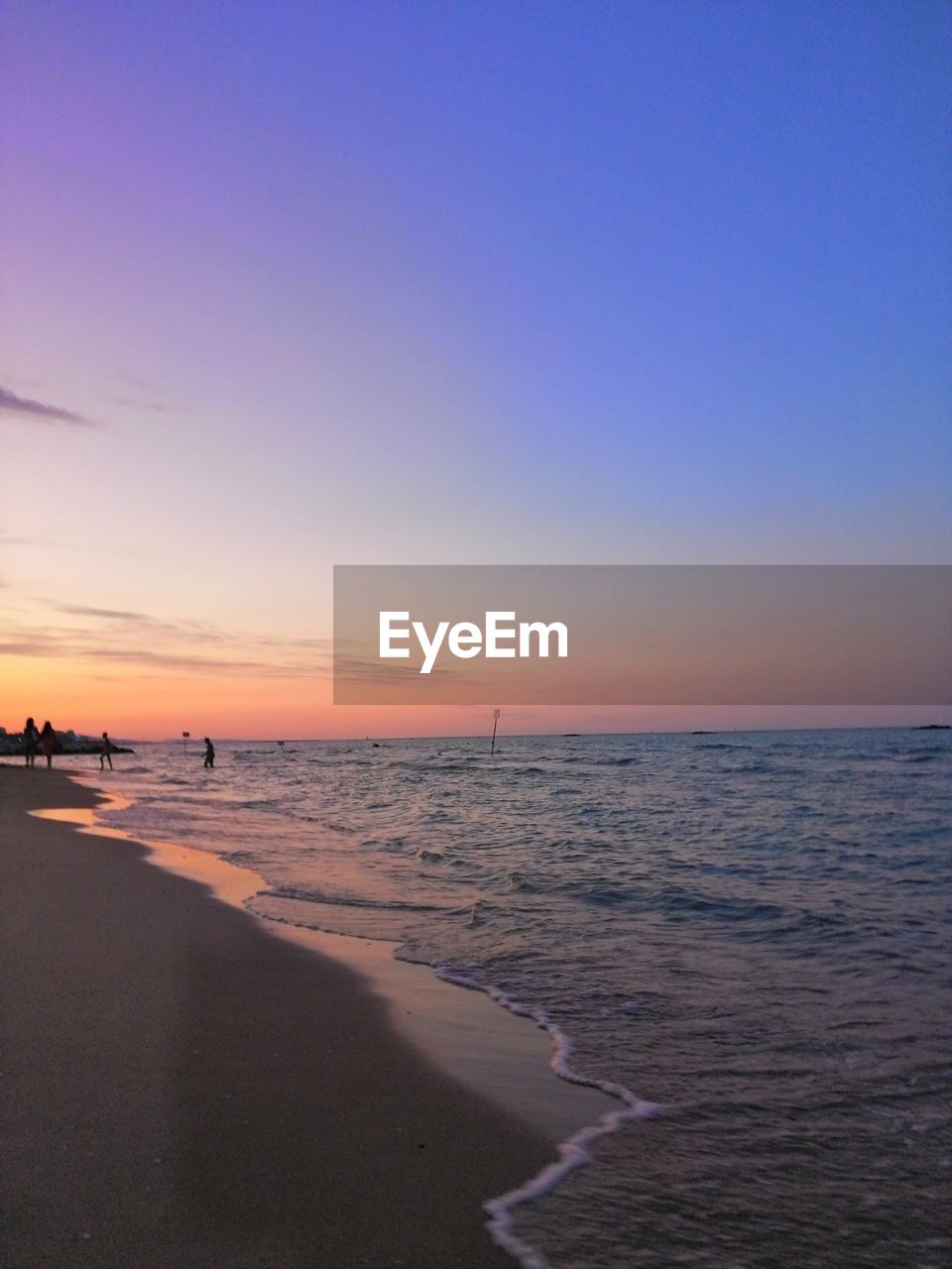 Scenic view of beach against sky during sunset