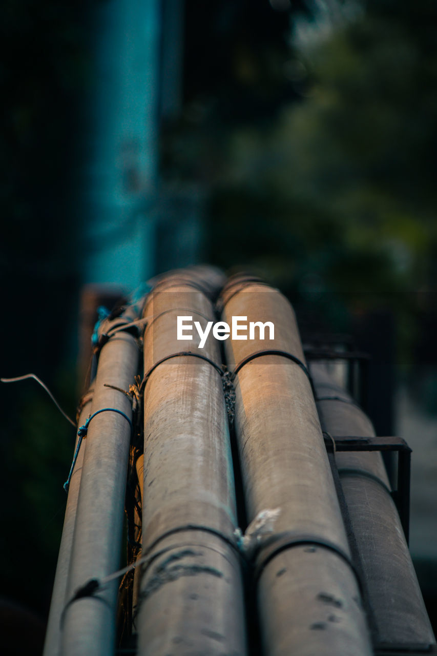 LOW ANGLE VIEW OF BAMBOO ON METAL STRUCTURE