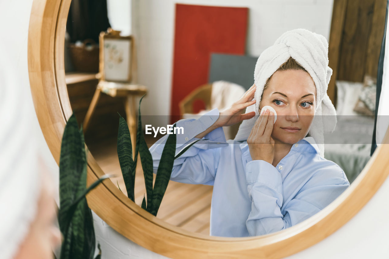 Portrait of smiling young woman in mirror