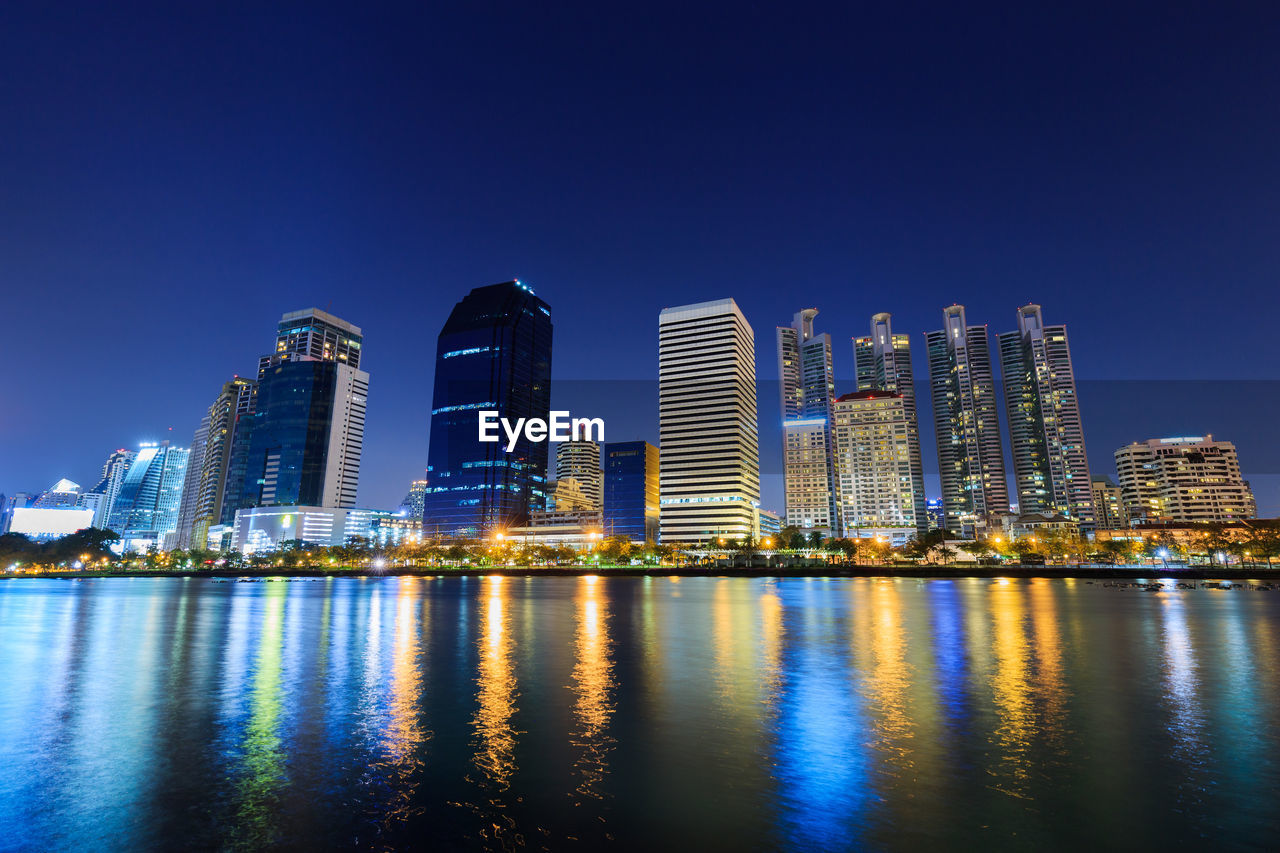 ILLUMINATED BUILDINGS AGAINST BLUE SKY