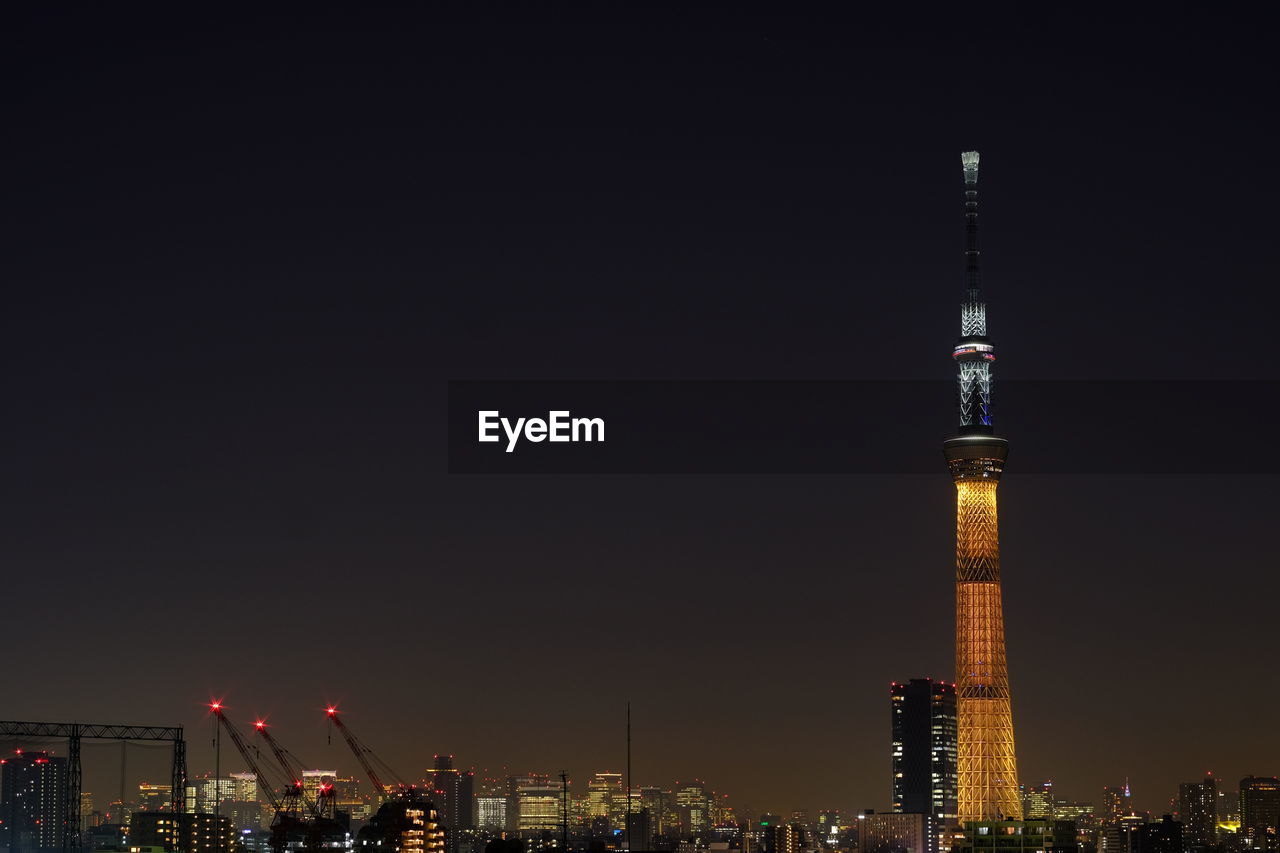 Low angle view of illuminated tower at night