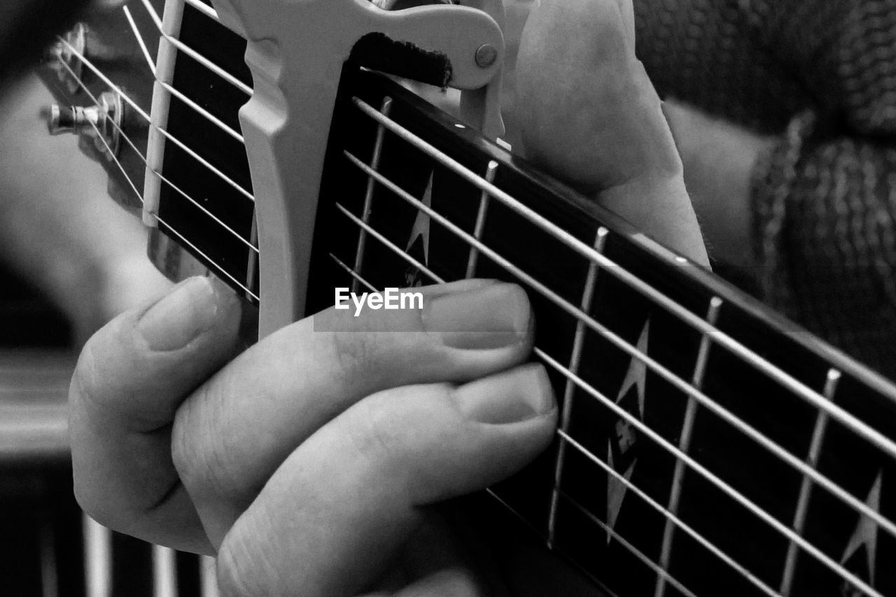 Close-up of man playing guitar