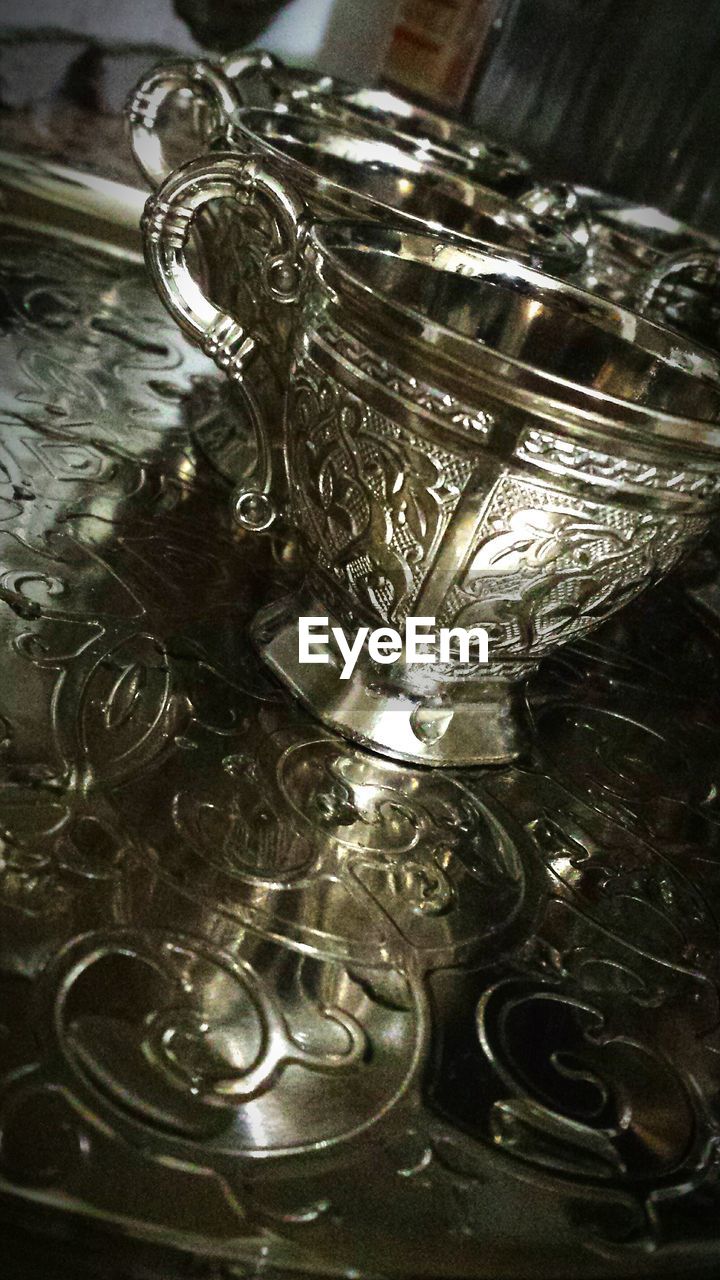 Tilt shot of antique cups on tray