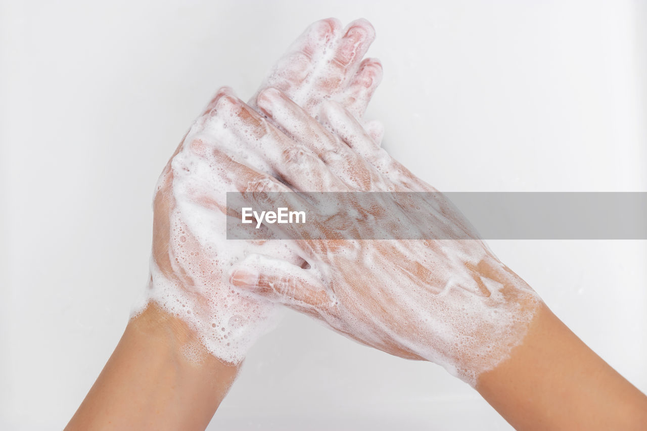 CLOSE-UP OF HAND ON WET GLASS