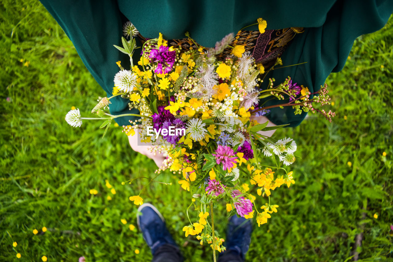 High angle view woman holding bouquet 