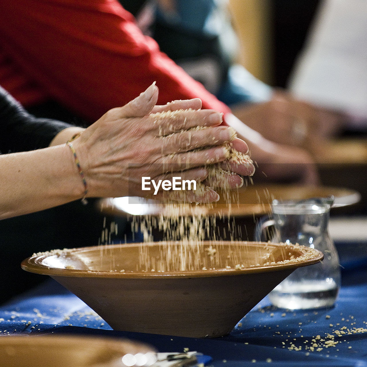 Cropped image of woman making wheat in bowl