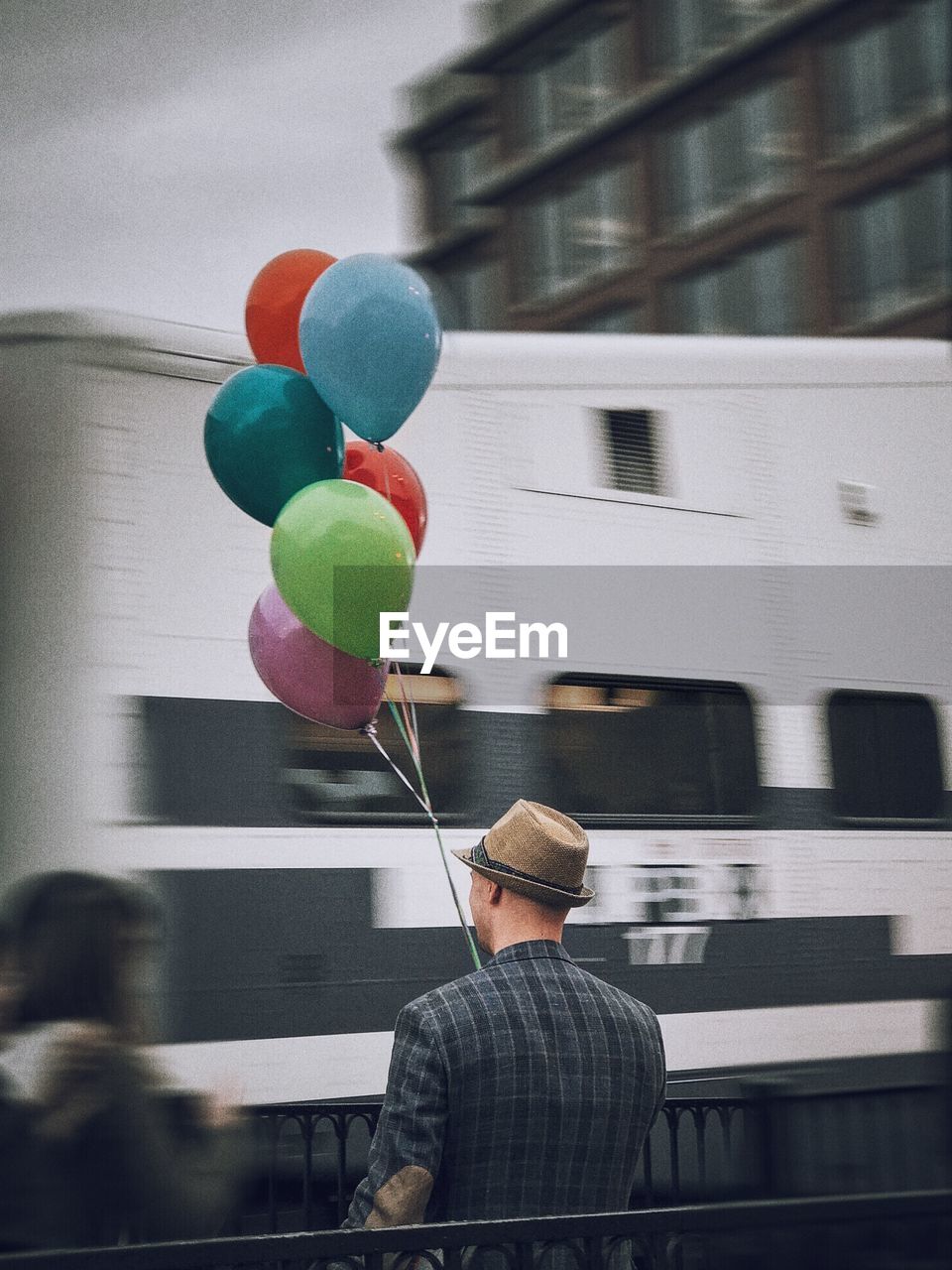 REAR VIEW OF MAN WITH BALLOON BALLOONS AT HOME