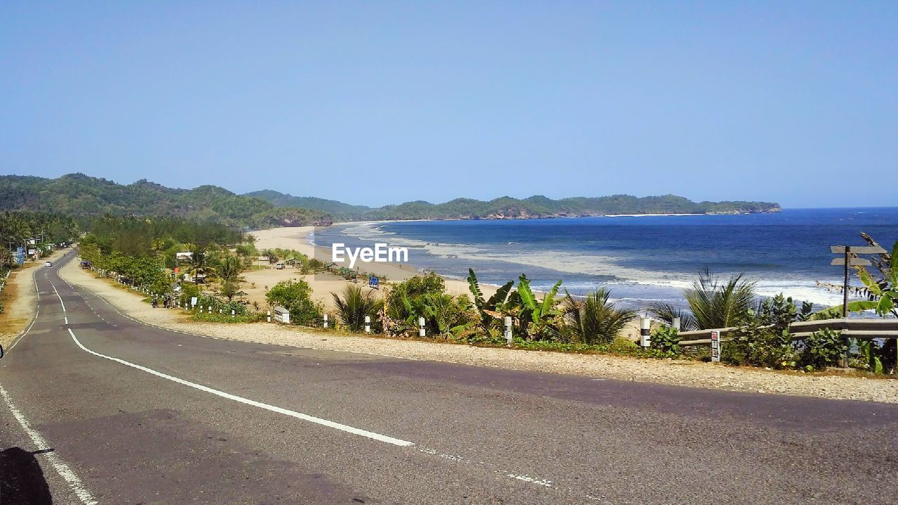 PANORAMIC VIEW OF ROAD BY SEA AGAINST CLEAR SKY