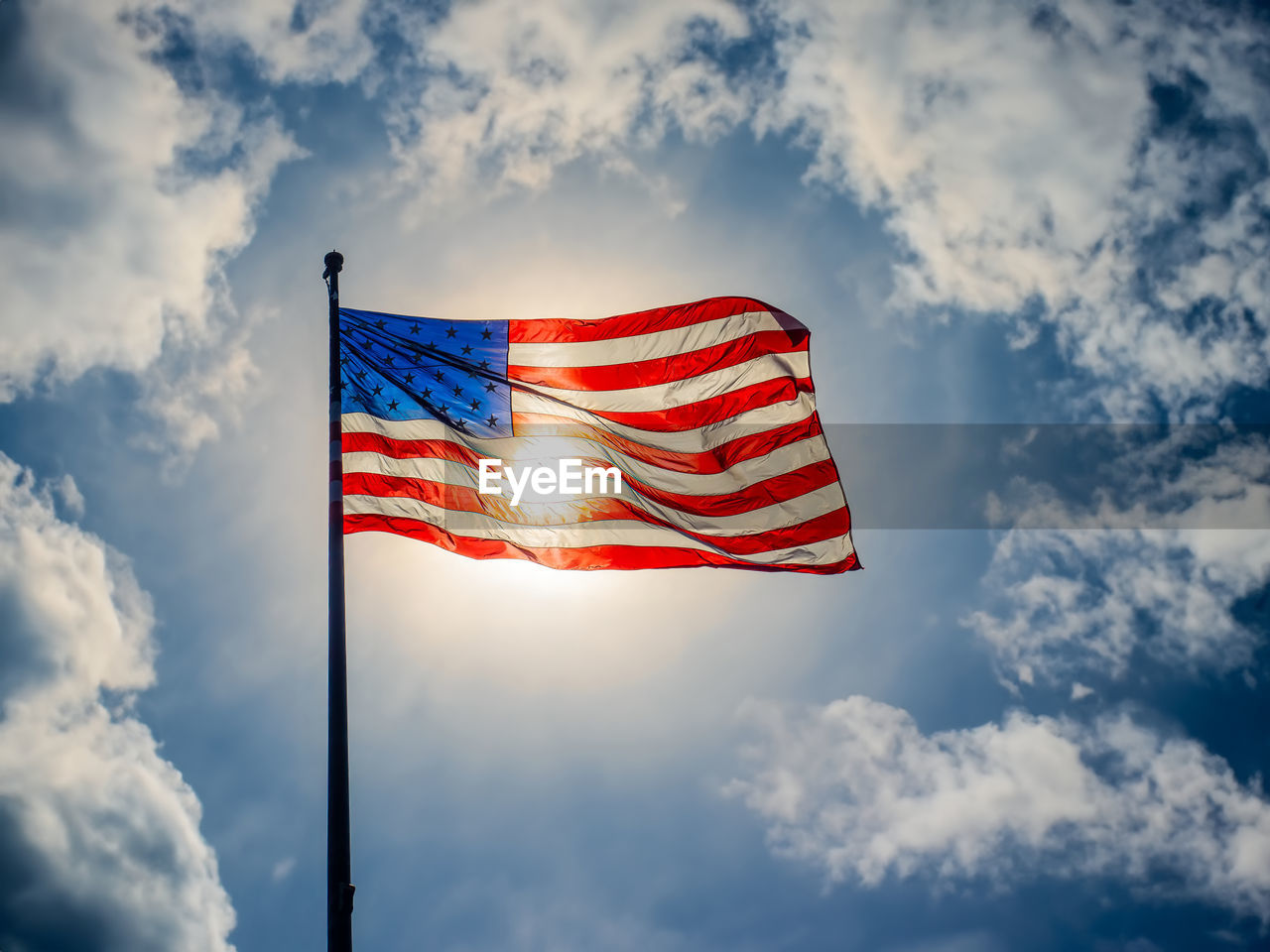 American flag against blue sky und sunlight