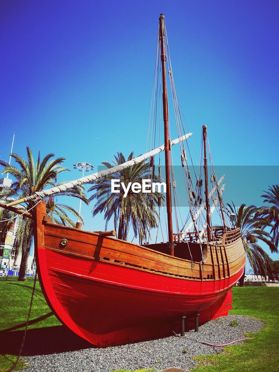 VIEW OF BOAT MOORED ON SHORE AGAINST CLEAR BLUE SKY