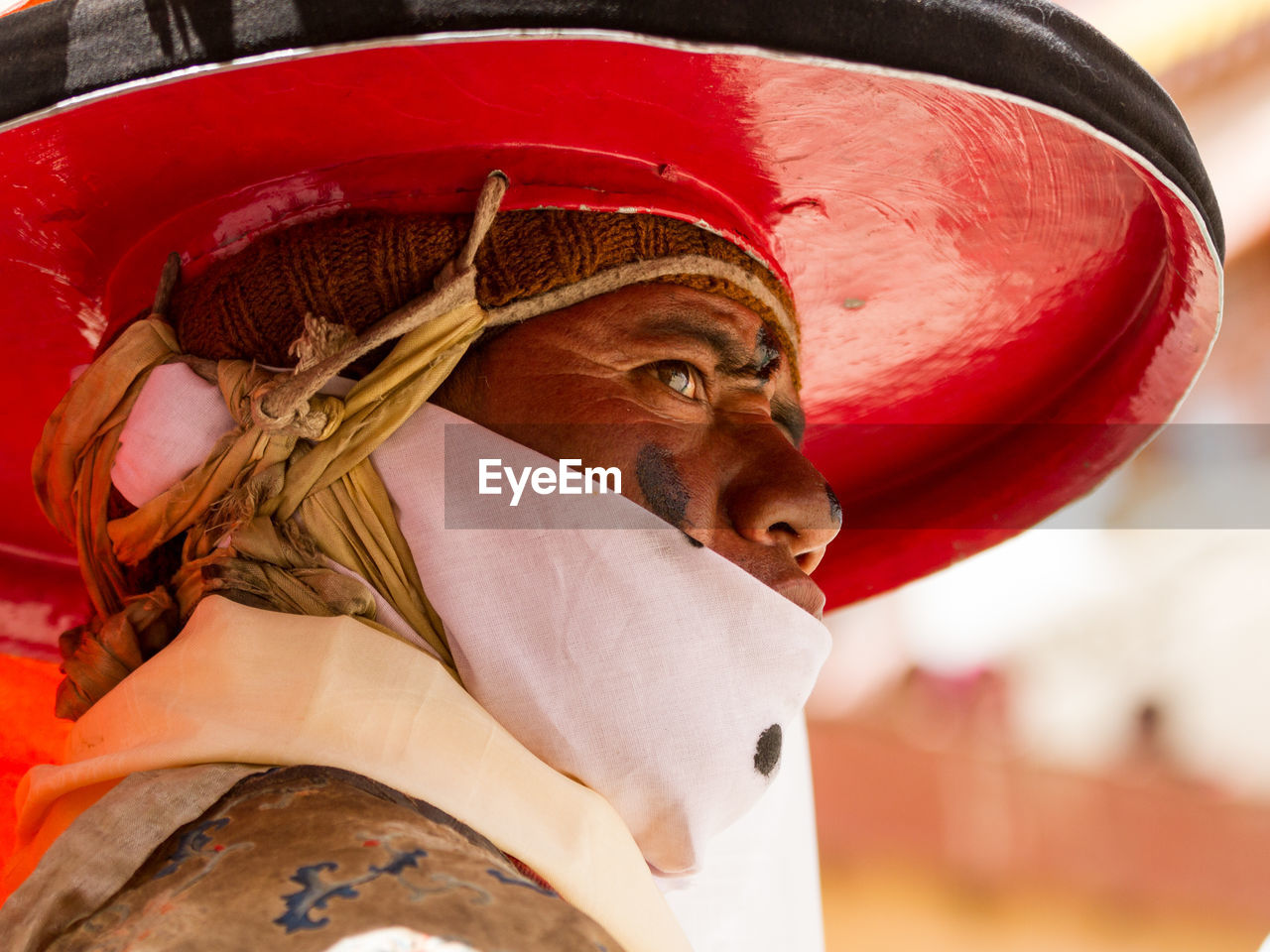 CLOSE-UP PORTRAIT OF RED MAN WEARING HAT