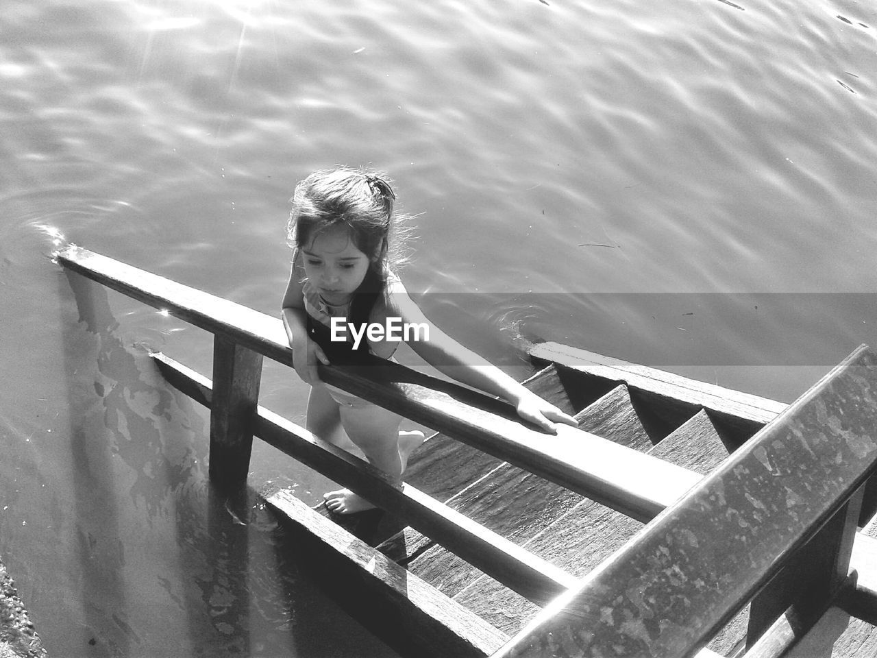 HIGH ANGLE PORTRAIT OF BOY IN LAKE AGAINST SKY