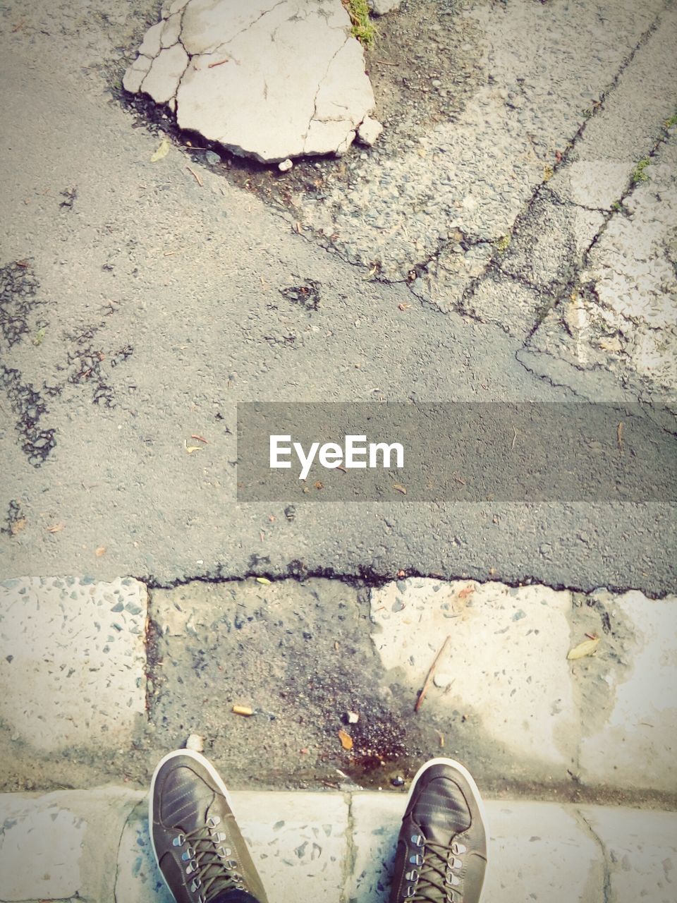 LOW SECTION OF MAN STANDING ON FOOTPATH