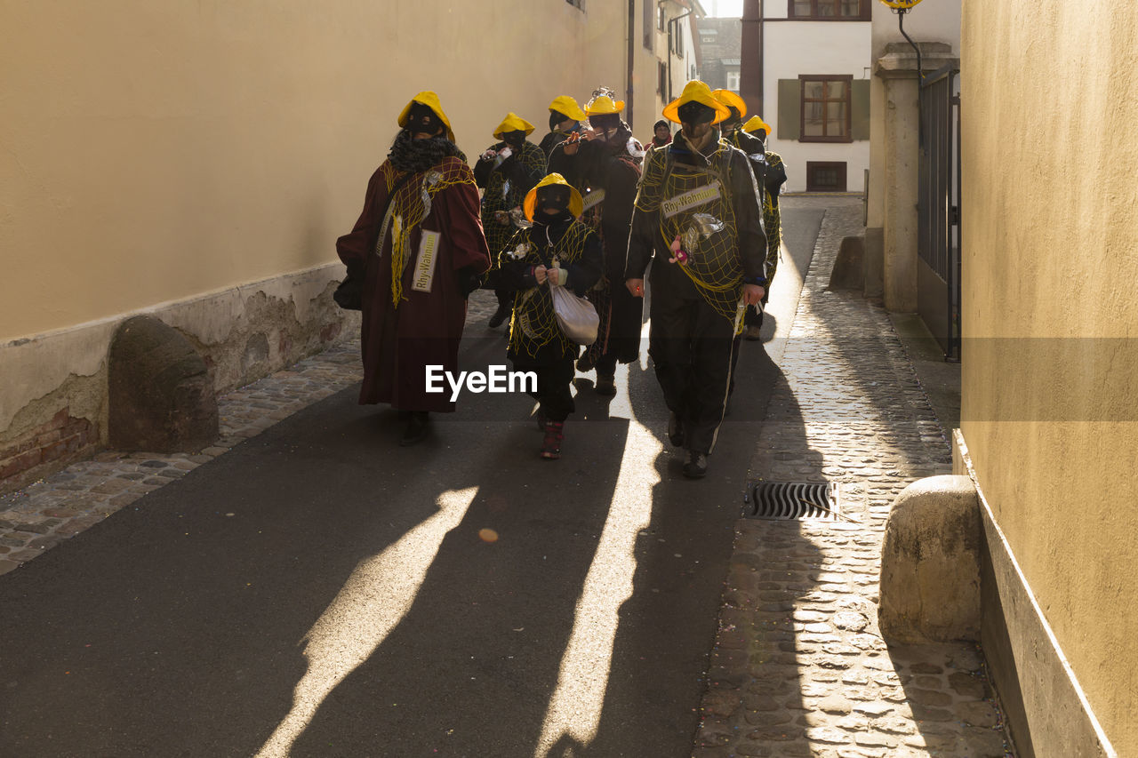 Basel carnival. basel, switzerland. feb 21st, 18. carnival group in dark costumes in the old town